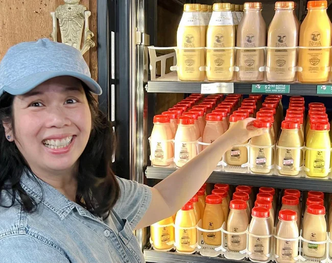 Cristie Lo affichant un réfrigérateur plein de lait rose